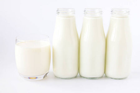 瓶牛奶和奶白色背景上的玻璃