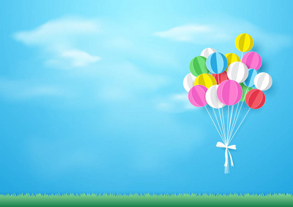 五颜六色的气球飞越草。纸的艺术和手工艺的风格