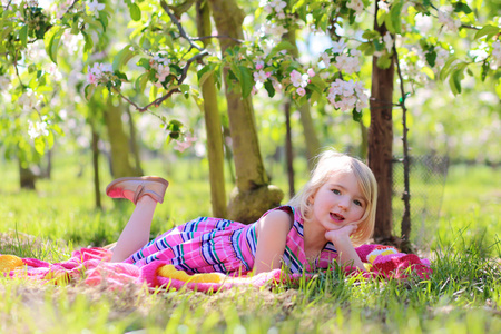 小女孩在盛开的水果园里玩耍