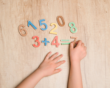 孩子手与简单数学方程对木制选项卡