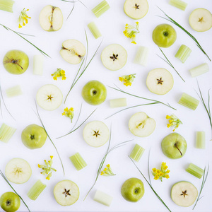 白色背景下的苹果花芹菜和草的食物成分