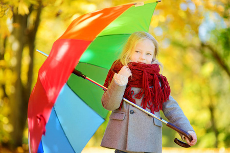小女孩抱着彩虹伞图片