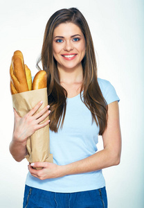 妇女拿着纸袋子与法国面包图片