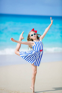活跃的小女孩在海滩有很多乐趣。运动的孩子在海边做体育项目