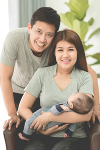 亚洲母亲和父亲在家与婴孩