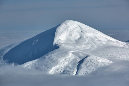 云层之上覆盖着积雪的山峰