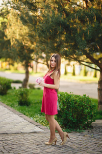 为照片拍照的年轻女孩的肖像。在背景开花粉红色的树。春天.樱花