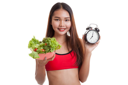 亚洲健康美女时钟和沙拉图片