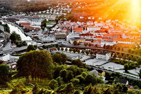太阳设置在一个传统的挪威邻里。查看在挪威的一个美丽的城市哈尔登在许多房子和街道在日落期间