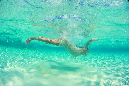 年轻貌美的女性穿着潜水在马尔代夫群岛附近的海洋
