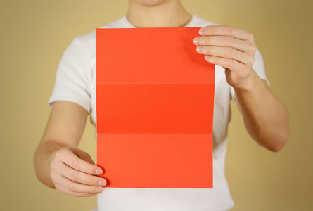 男人显示空白的红色海报宣传册小册子。单张高分。