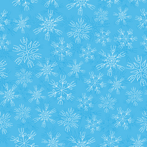 白色的雪花飘落在蓝色背景无缝模式