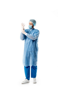 身穿蓝色制服的外科医生戴着白色的医用手套