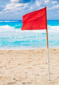 暴风雨海滩上的红色警告旗
