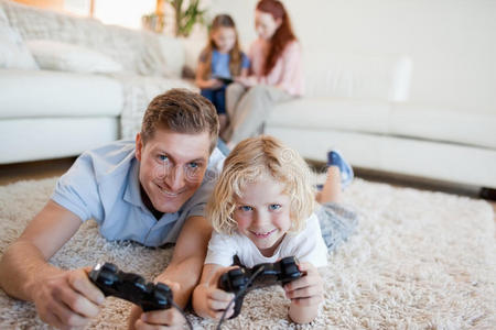 爸爸和儿子在客厅玩电子游戏图片