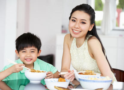 中国母子坐在家里吃饭
