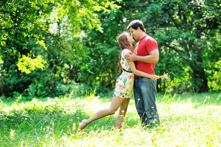快乐的年轻夫妇在公园里亲吻