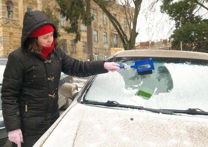 女人擦雪车挡风玻璃