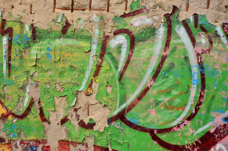 详细的形象, 非常古老和陈旧的彩色涂鸦画在墙上。背景垃圾街头艺术图片