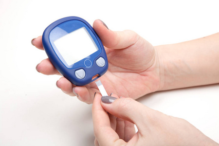 女人手测试高血糖与血糖仪的特写镜头