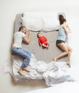 幸福家庭与一个新生的孩子在卧室的最高视图