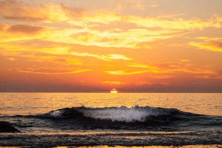 海浪背景下的美丽的日落。定了调子