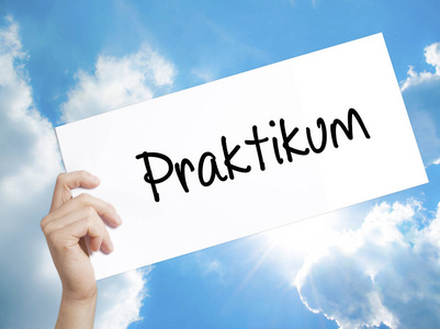 Praktikum 在德国实习 标志在白纸上。男人的手