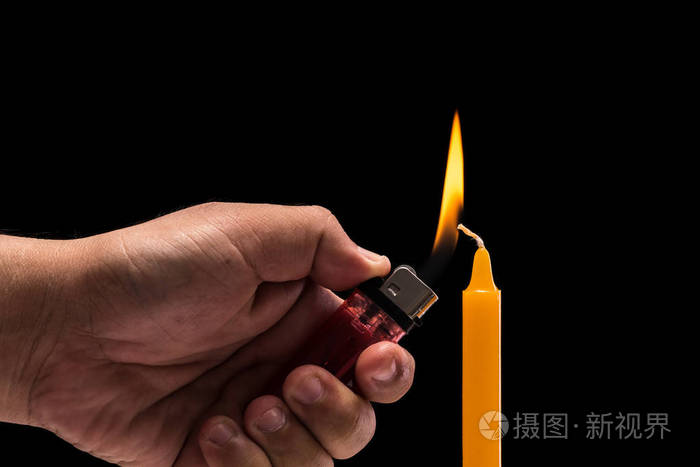 手里拿的燃烧气体打火机蜡烛光影棚拍摄是