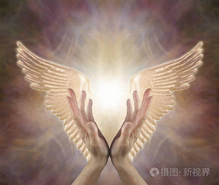 引导天使般的疗愈能量--女性手伸向金色天使的翅膀两边在温暖色调的