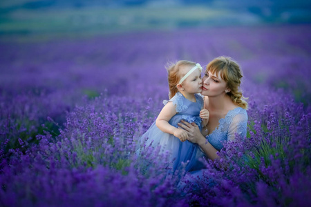 母亲和女儿在薰衣草田野上摆姿势