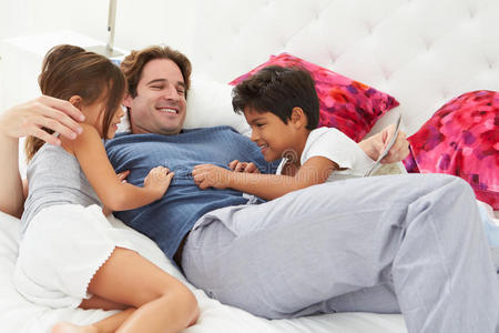 爸爸和孩子们一起在床上放松