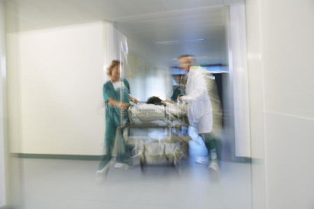 医生把病人抬上轮床，穿过医院走廊