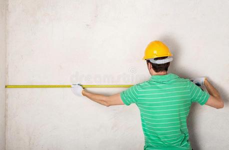 测量石膏墙的工人