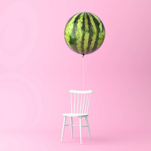 气球西瓜与椅子概念在柔和的粉红色背景。最小的想法食物和果子概念。在广告营销传播或艺术品设计中创造作品的创意