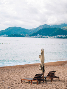 日光浴浴床和在海滩上的遮阳伞。黑山的海滩