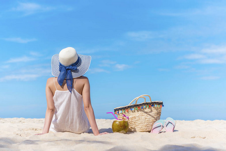 夏天在海滩上。旅游背景的概念, 美丽的女人后侧坐在沙滩上仰望蓝天。快乐的假期和漫长的周末。图片添加文字信息, 设计艺术作品