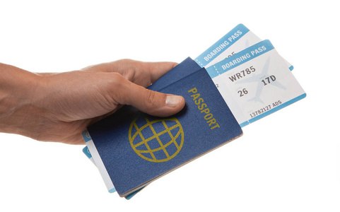男子持有护照和飞机票在他的手。在白色上隔离