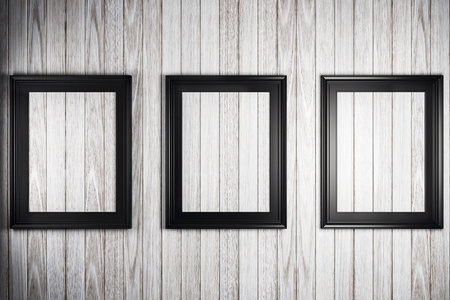 三张黑色的镜框在轻木墙上。3d 渲染