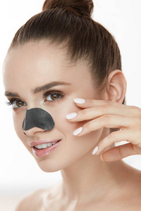 清洁皮肤。与修补程序面具上鼻子特写美丽的女人