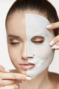 爱美的女性脸上的皮肤治疗。戴着白色的床单面具的女人