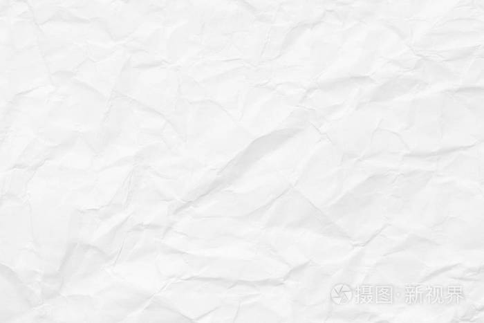 有凹痕和扭结的白纸的质地皱巴巴的表面背景