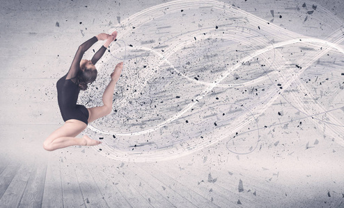 演出的芭蕾舞演员跳起后能量爆炸粒子