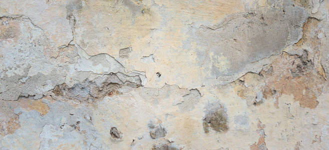 旧墙上有果皮灰色的灰泥质地。复古复古旧墙背景。腐朽裂纹粗糙抽象横幅表面