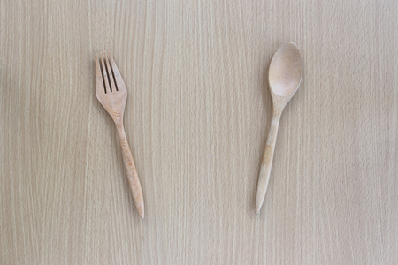 木勺子和叉子在俯视图中木背景图片