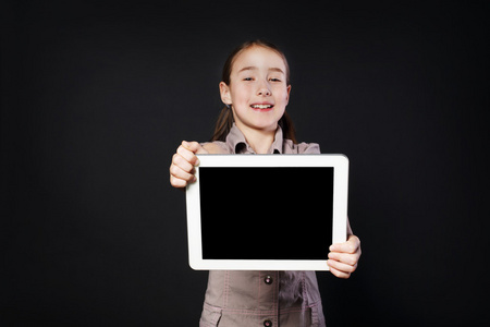 小女孩展示了白色数码平板电脑的空屏幕