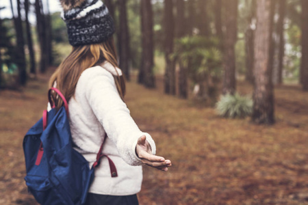 在森林里漫步的年轻女子旅行者