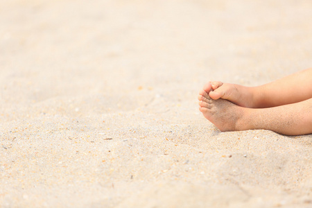 孩子脚在海滩上的沙子