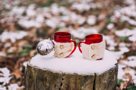 杯子和圣诞球在树桩上