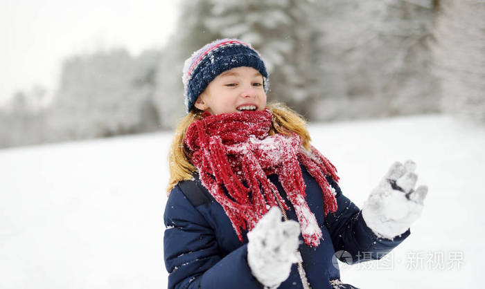 可爱的小女孩,美丽的冬季公园玩得开心.可爱的孩子在雪地里玩.