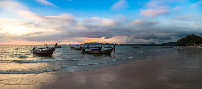 夏季日在泰国奥南海滩日落时传统长尾船全景